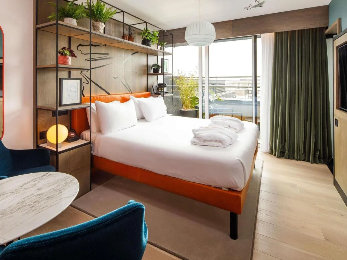 A hotel room with a large bed and table at ibis Styles Edinburgh St Andrew Square